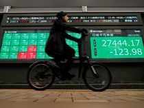 Screen displays Nikkei share average and stock indexes outside a brokerage in Tokyo