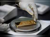 An employee weighs a 1kg gold bar at AGR (African Gold Refinery) in Entebbe