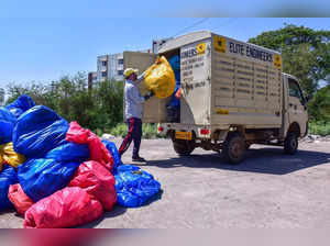 Jabalpur: A health worker unloads plastic bags of medical waste for disposal, at...