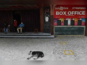 Mumbai: A guard rests outside a multiplex after authorities closed cinemas as a ...