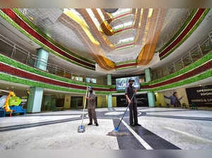 Bengaluru: Workers clean the premises of a mall after authorities allowed malls ...