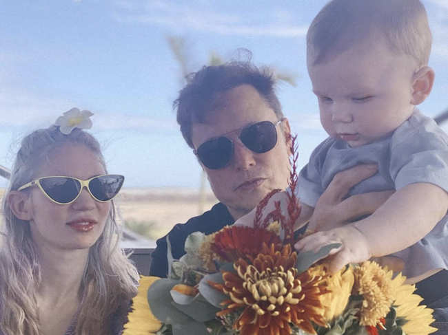 ​Elon Musk (C) with girlfriend Grimes (L) and their son X Æ A-Xii​.