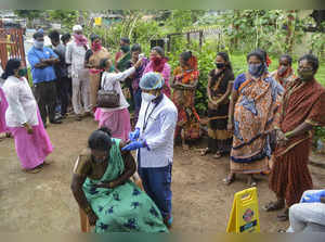 Karad: A health worker administers a dose of COVID-19 vaccine to a scrap collect...