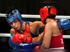 Tokyo: India's Lovlina Borgohain (blue) exchanges punches with Busenaz Surmeneli...