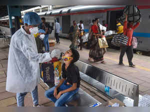 Mumbai: A BMC health worker takes swab sample of a passenger for COVID-19 test, ...