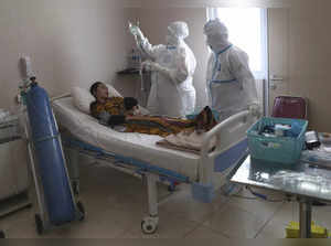 Health workers treat a COVID-19 patient