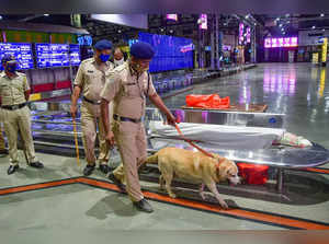 Mumbai: Police personnel along with a sniffer dog during a search operation at C...