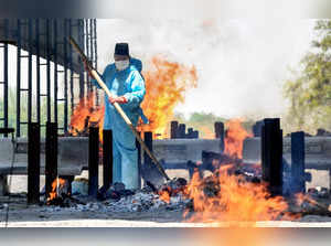 Jabalpur: Inayat Ali, a Muslim, performs cremation of a body, at crematorium in ...
