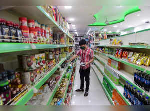 **EDS, TO GO WITH STORY** New Delhi: An Afghan salesman arrange items at a store...