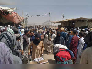 Chaman:  Afghan families enter Pakistan through a border crossing point in Chama...