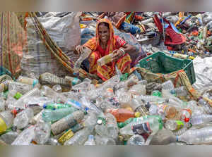 Nadia: A woman sorts plastic bottles on World Environment Day, in Nadia. (PTI Ph...
