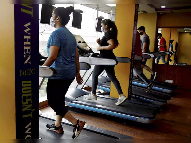 New Delhi: Fitness enthusiasts workout in a gym that reopened after authorities ...