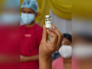 A medic displays a vial of Covaxin vaccine at a vaccination centre in...