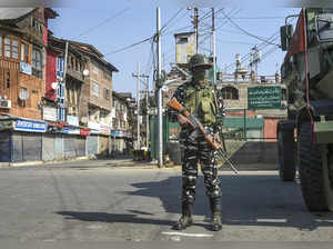 Srinagar: A security personnel stands guard during restrictions in Srinagar.  Re...