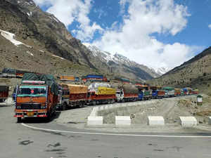 Kelong: Trucks carrying supplies move on the Manali-Leh road after it was reopen...