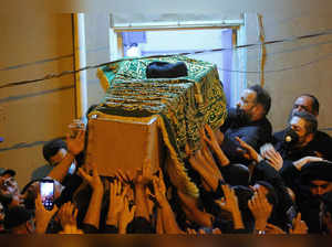 Najaf: Mourners escort the coffin of Grand Ayatollah Sayyid Mohammed Saeed al-Ha...