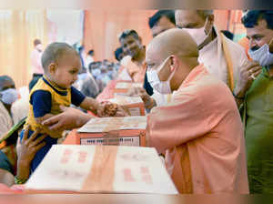 Gonda: Uttar Pradesh Chief Minister Yogi Adityanath plays with a child as he mee...