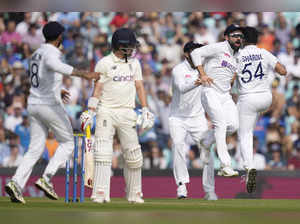 London: India's captain Virat Kohli celebrates as India's Shardul Thakur, right,...