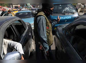 A member of the Taliban directs traffic in Kabul