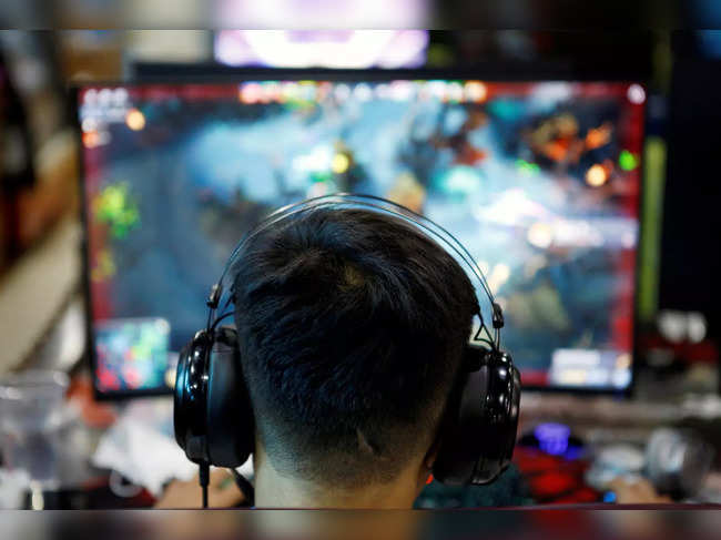 FILE PHOTO: Man plays online game on a computer at an internet cafe in Beijing