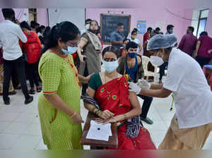 Thane: A health worker administers a dose of COVID-19 vaccine to a teacher, as t...