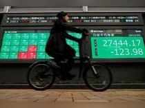 Screen displays Nikkei share average and stock indexes outside a brokerage in Tokyo