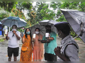 Kolkata: Morning walkers show their COVID-19 vaccinated certificate in mobile ph...