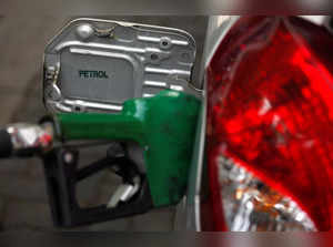A nozzle pumps petrol into a vehicle at a fuel station in Mumbai