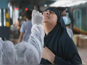 Mumbai: A BMC health worker takes swab sample of a passenger for COVID-19 test, ...