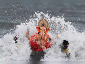 People carry an idol of the Hindu God Ganesh, the deity of prosperity, for immersion off the coast of the Arabian sea on the last day of the Ganesh Chaturthi festival in Mumbai