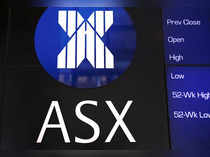 FILE PHOTO: A board displaying stock prices is adorned with the Australian Securities Exchange (ASX) logo in central Sydney