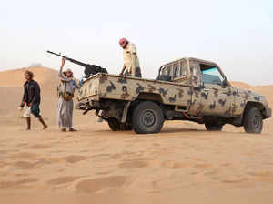 Armed men loyal to the government forces guard a site near the Safer oil fields in Marib