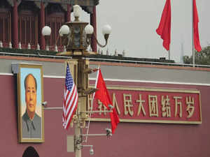 BEIJING, CHINA - NOVEMBER 09: China and US flag is displayed in front of the portrait of China's late communist leader Mao Zedong outside the Forbidden City on November 9, 2017 in Beijing, China. At the invitation of Chineses President Xi Jinping, U.S President Donald Trump is to pay a state visit to China from November 8 to 10. (Photo by Lintao Zhang/Getty Images)