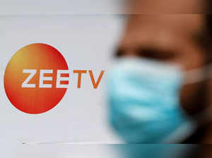 A guard stands next to a banner of Zee television outside a film studio in Mumbai