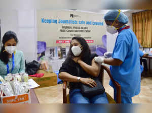 Mumbai: A health worker administers a dose of the COVID-19 vaccine to a journali...
