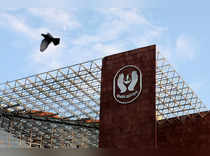 FILE PHOTO: Bird flies past a logo of Life Insurance Corporation of India (LIC) in New Delhi