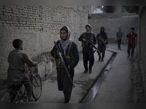 Taliban fighters patrol -AP