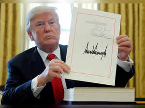 FILE PHOTO: U.S. President Trump displays signature after signing tax bill into law at the White House in Washington