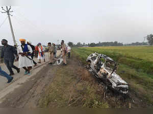 Lakhimpur Kheri: People take a look at the overturned SUV which destroyed in yes...