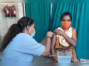 Gurugram: A health worker administers a dose of COVID-19 vaccine to a beneficiar...