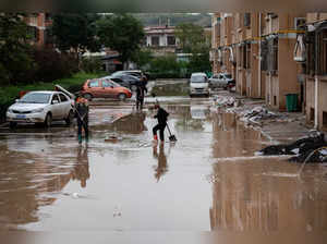 Villagers clear flooded waters near residential houses following heavy rainfall in Yitang county, Jiexiu city, Shanxi