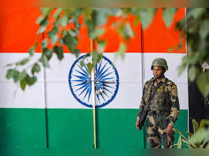 Suchetgarh: A BSF personnel stands guard during Retreat Ceremony at Octroi Post ...