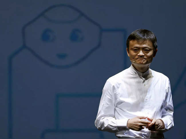 FILE PHOTO: FILE PHOTO: Jack Ma, founder and executive chairman of China's Alibaba Group, speaks in front of a picture of SoftBank's human-like robot named 'pepper' during a news conference in Chiba