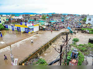 Aurangabad: People wade through a flooded area after heavy rainfall in Aurangaba...