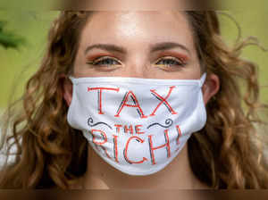 FILE PHOTO: NDP supporter wears "Tax the Rich" mask