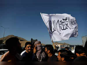 A member of the Taliban holds a flag in Kabul