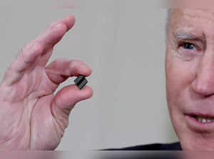 FILE PHOTO: FILE PHOTO: U.S. President Biden holds a semiconductor chip