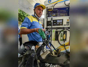 New Delhi: A pump attendant fills petrol in a vehicle at a refilling station as ...