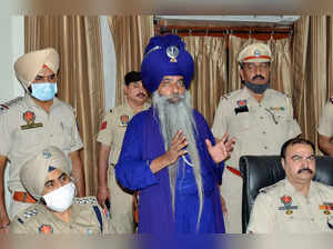 Amritsar: Police personnel with accused Nihang Singh for his alleged involvement...