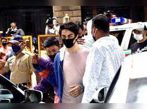 Mumbai: Aryan Khan, arrested in drugs case, being escorted at the NCB office aft...